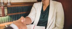woman shaking hands with business partner